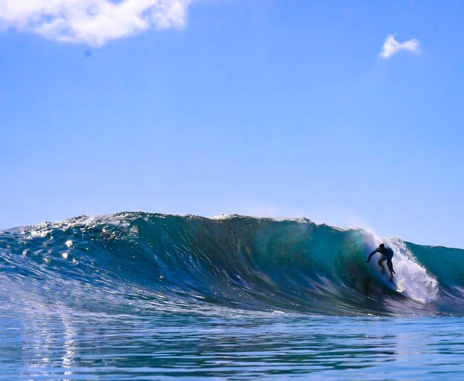 A surfer paddling out to a boat-access break in Bocas del Toro